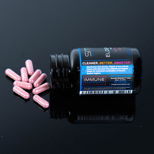 Bottle laying on its side on a table showing Elderberry supplements spilled out