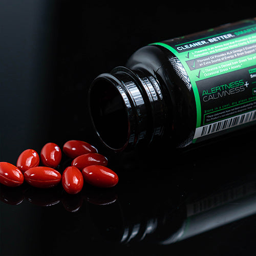 Close up of Smarter L-Theanine supplements spilled on a table next to a bottle of Smarter L-Theanine.