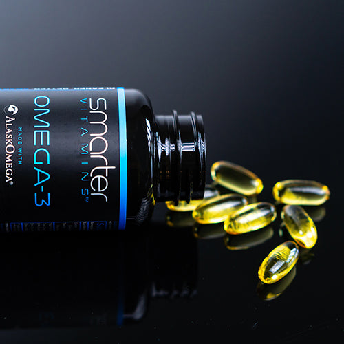 Close up of Smarter Omega-3 bottle sideways pouring supplements onto a table Randy Jabero