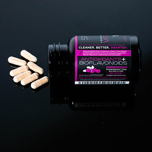 Smarter Vitamin C bottle laying on a table with Vitamin C supplements spilled out