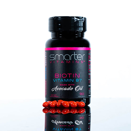 Bottle of Smarter Biotin vitamin B7 with supplements on a reflective table