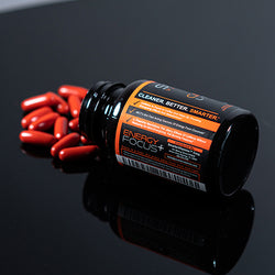 A bottle of Smarter Caffeine L-Theanine on a table pouring out Caffeine supplements.