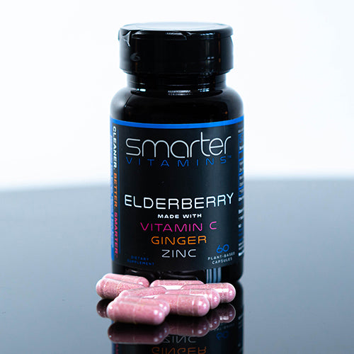 Bottle of Smarter Elderberry on a table surround by Elderberry supplements