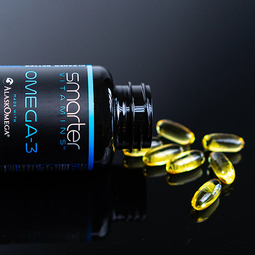 Close up of Smarter Omega-3 bottle sideways pouring supplements onto a table