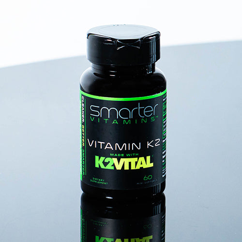 Bottle of Smarter Vitamin K2 made with K2VITAL on a reflective table 