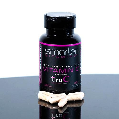 Smarter Vitamin C bottle on a table with Vitamin C supplements surrounding the bottle Randy Jabero